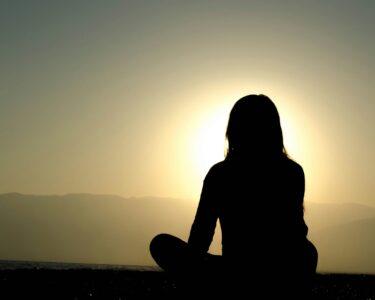 woman sitting on sand