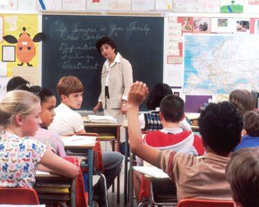 woman standing in front of children