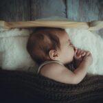 baby's sleeping on white comforter