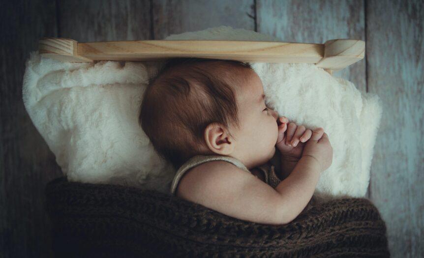 baby's sleeping on white comforter
