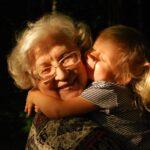 woman in black and white striped shirt hugging girl in black and white striped shirt