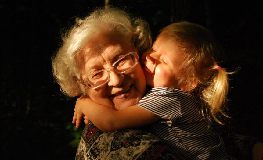 woman in black and white striped shirt hugging girl in black and white striped shirt