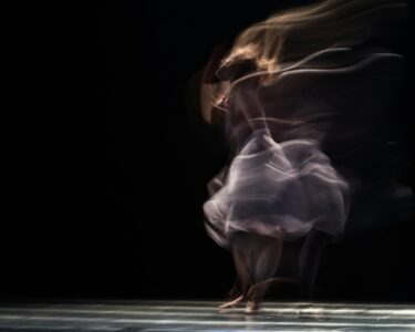 dancing woman on concrete pavement