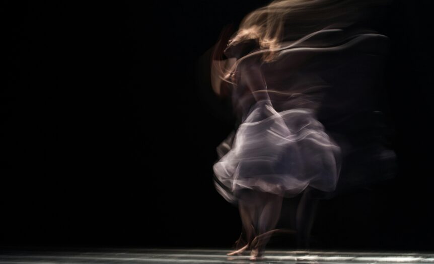dancing woman on concrete pavement