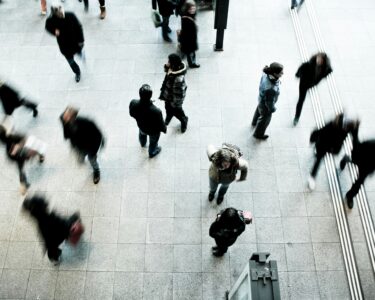 people walking on grey concrete floor during daytime