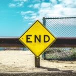 End sign on beige sand