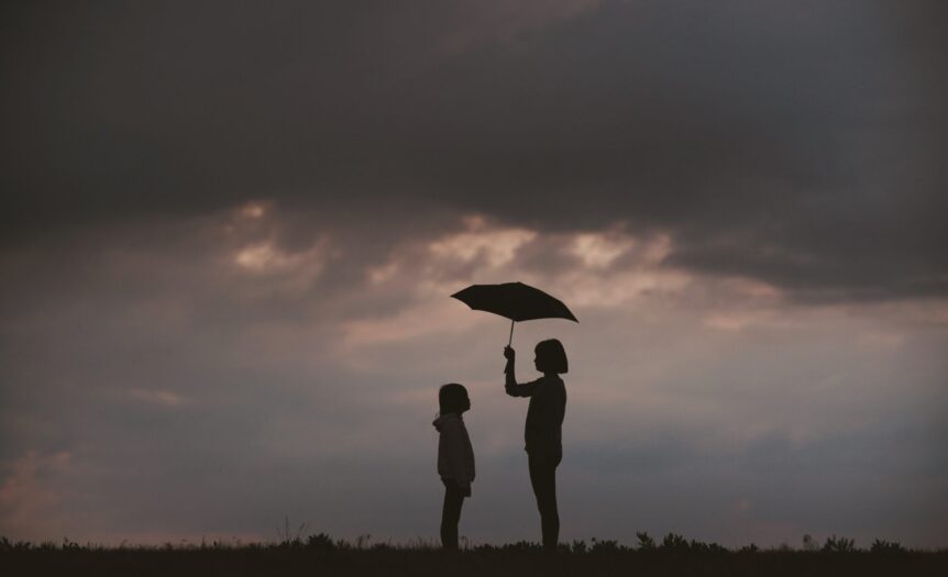 girl holding umbrella on grass field