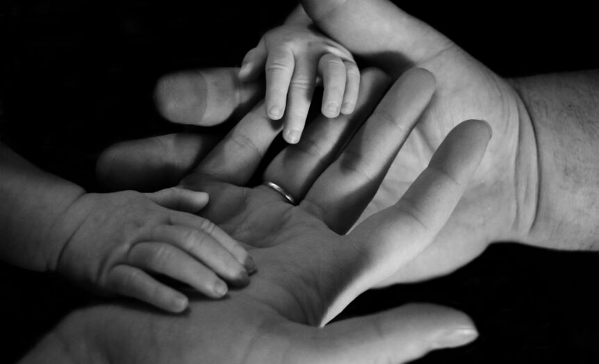 babys hand on human palm