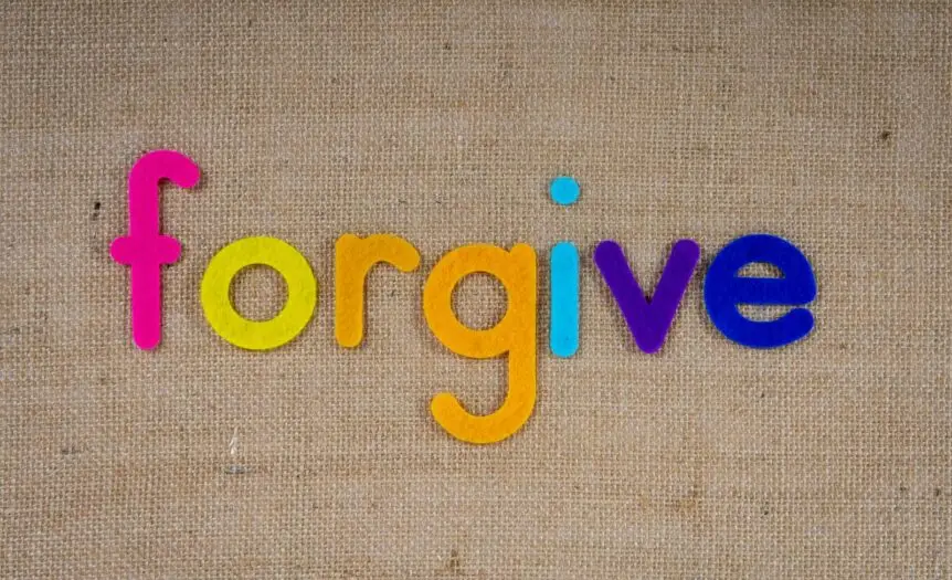 Vibrant felt letters spelling 'forgive' on a burlap background.