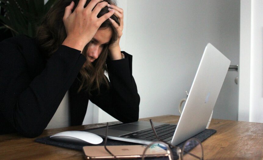 a woman sitting in front of a laptop computer