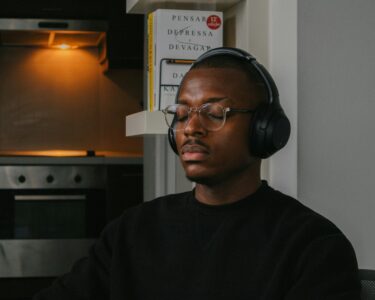 a man wearing headphones sitting in a chair