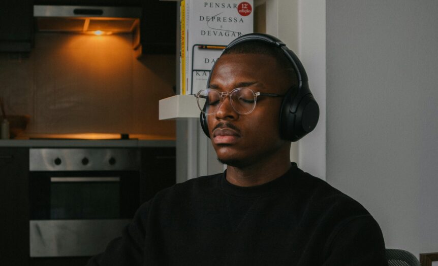 a man wearing headphones sitting in a chair