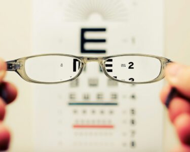 person holding eyeglasses