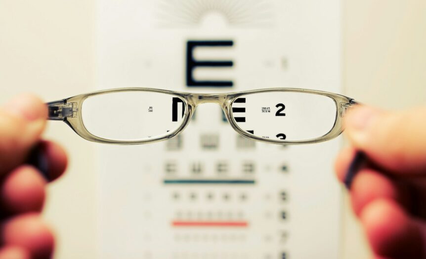 person holding eyeglasses