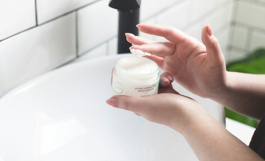 person holding white and black plastic bottle