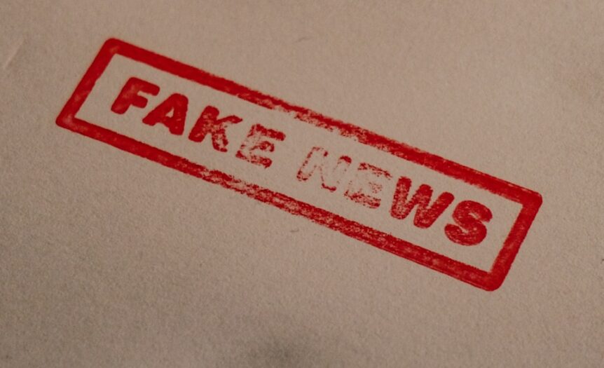 a stamp that reads fake news on a piece of paper