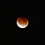 brown moon on black background