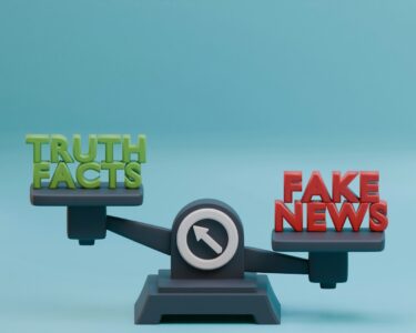 a scale with the words fake news on it