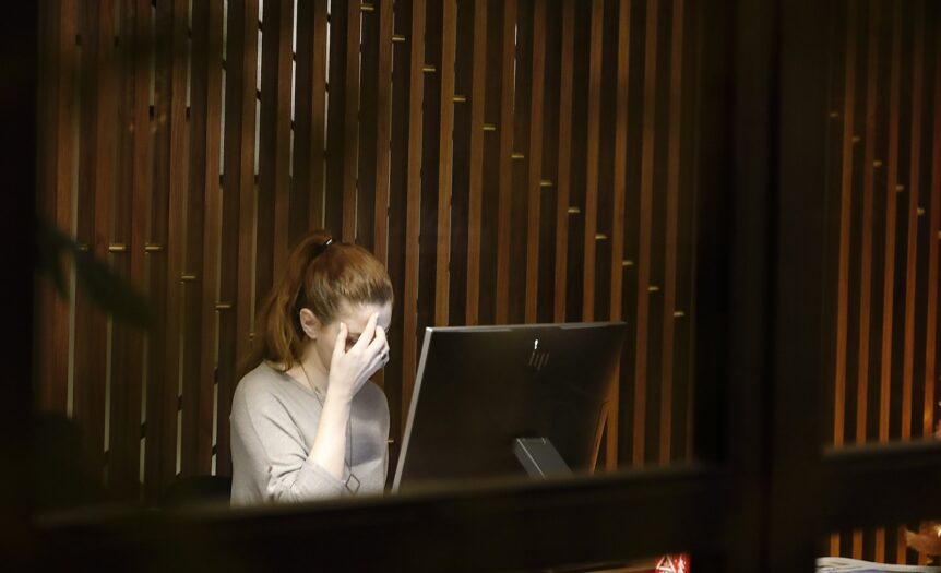 Burnout a woman sitting in front of a laptop computer