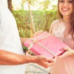 smiling woman giving valentine gift her boyfriend