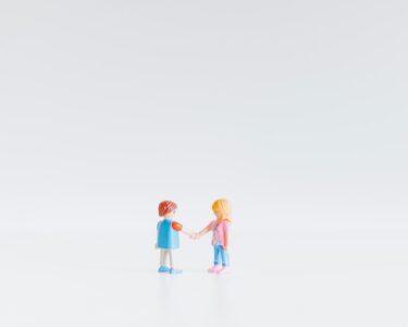 3 children in white and blue shirts
