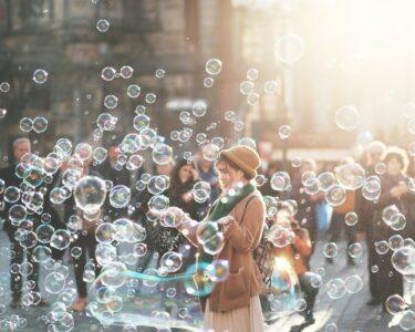woman standing outdoor surrounded by bobbles during daytime