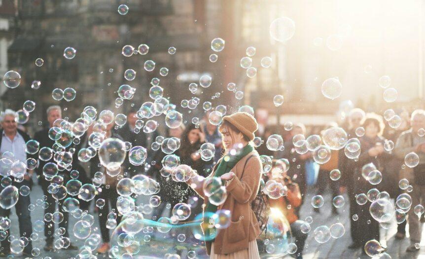 woman standing outdoor surrounded by bobbles during daytime