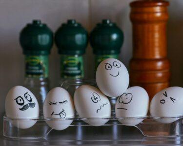 white and black eggs on glass rack