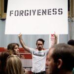 person holding Forgiveness poster