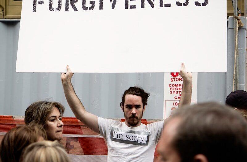 person holding Forgiveness poster