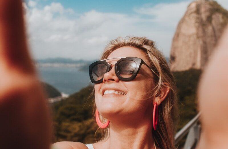 woman in white tank top wearing black sunglasses