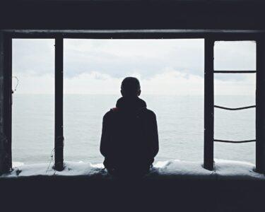 person looking out through window