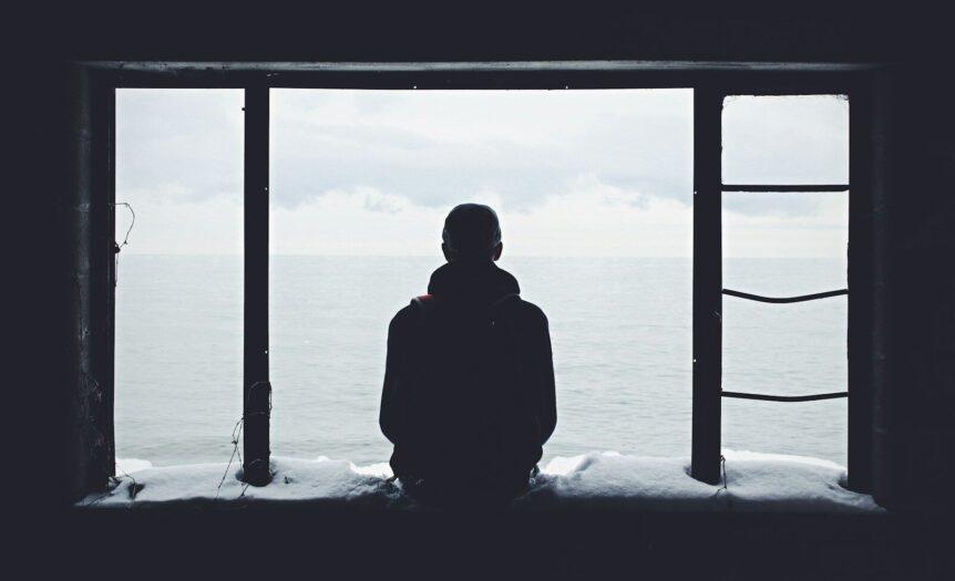 person looking out through window