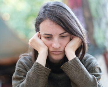 a woman holding her head in her hands