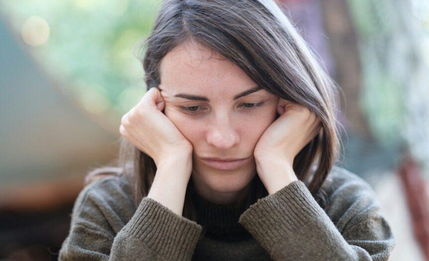 a woman holding her head in her hands
