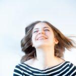woman in white and black striped shirt