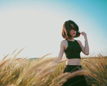 woman on wheat field during daytime