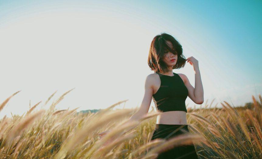 woman on wheat field during daytime